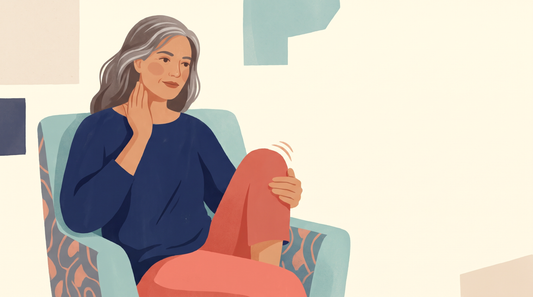 Woman in an armchair touching her neck and rubbing her knee
