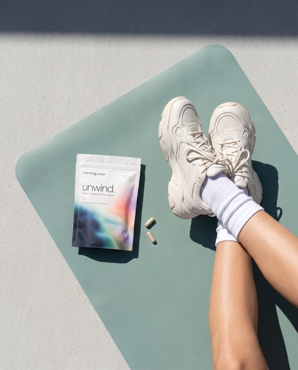 unwind. on a yoga mat beside crossed sneakers